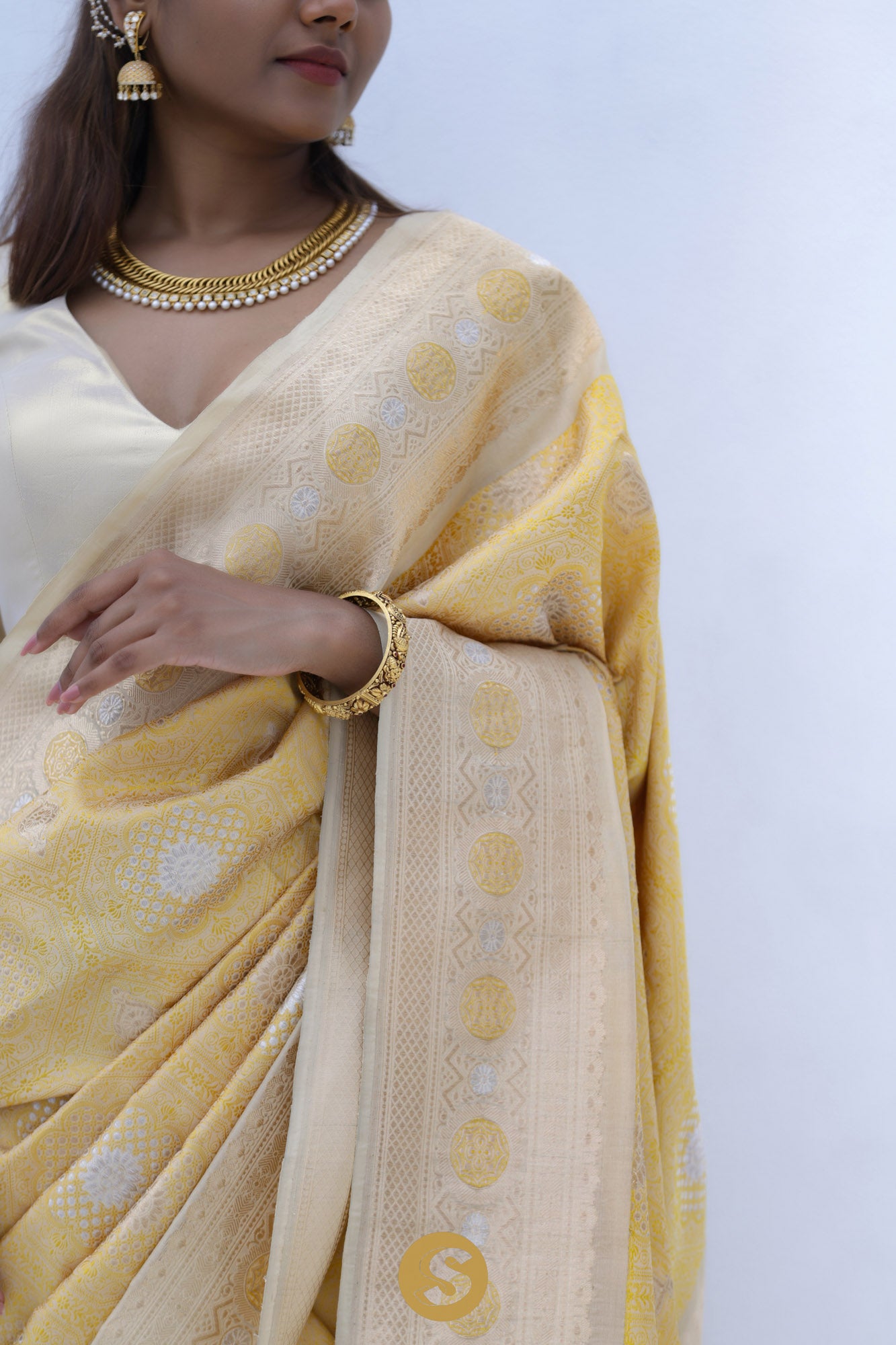 Pastel Yellow Banarasi Silk Saree With Floral Butti Weaving